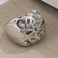 Clean, angled shot of the ring on a finger or stand, showcasing the dramatic 3D dome shape of the pendant.
