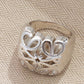 Clean, angled shot of the ring on a finger or stand, showcasing the dramatic 3D dome shape of the pendant.