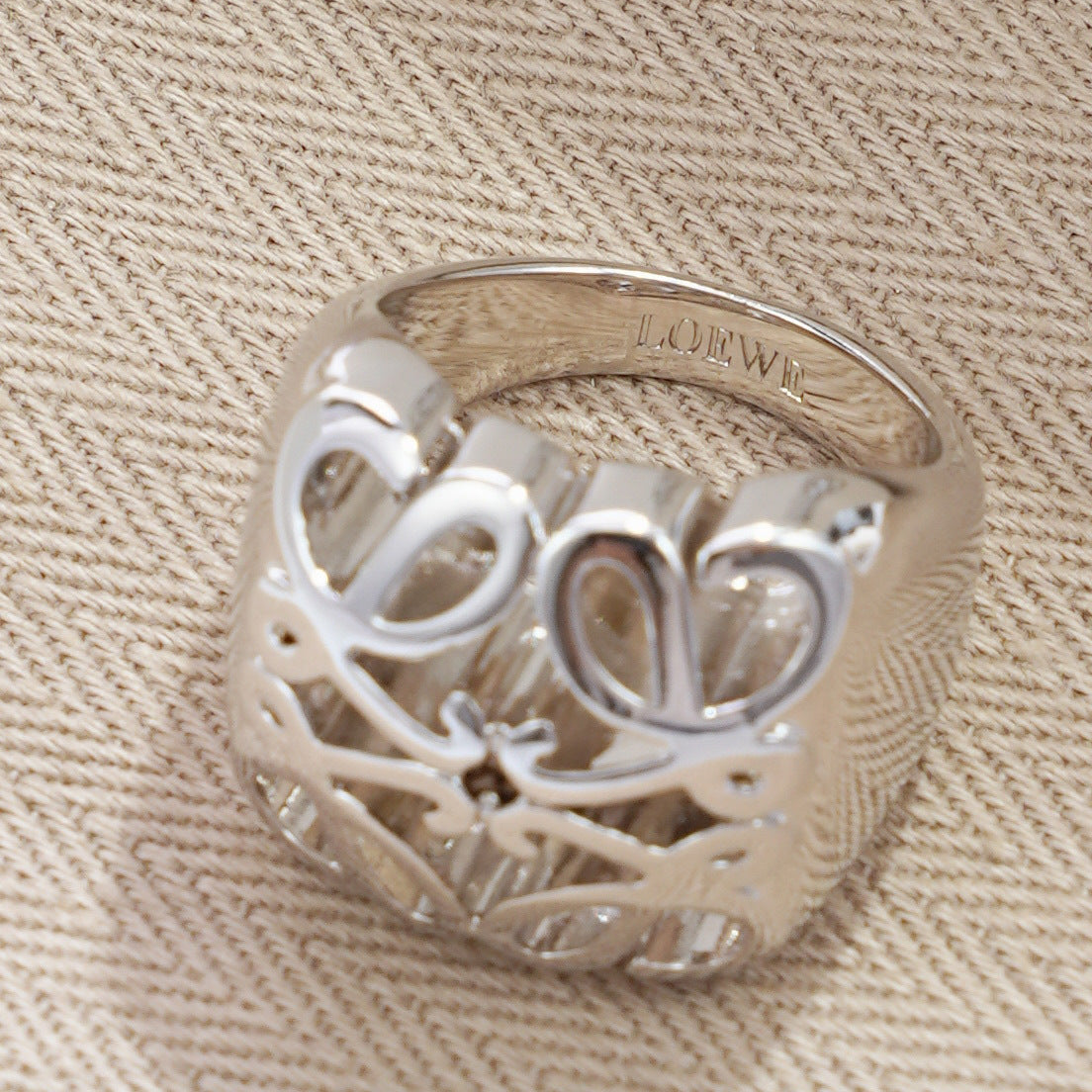 Clean, angled shot of the ring on a finger or stand, showcasing the dramatic 3D dome shape of the pendant.