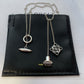  Clean, direct shot of the necklace on a plain background, clearly showcasing the Anagram charm and the fine chain.
