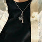  A model with a sleek, modern style wearing the necklace with a simple top, demonstrating its effortless elegance.