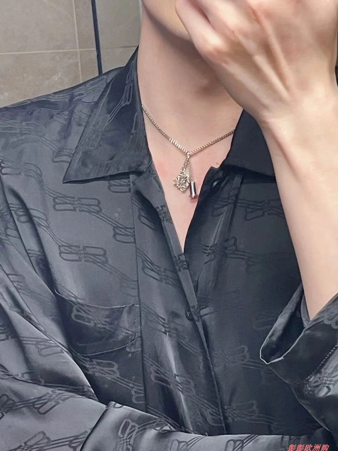  A model with a sleek, modern style wearing the necklace with a simple top, demonstrating its effortless elegance.