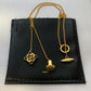  Clean, direct shot of the necklace on a plain background, clearly showcasing the Anagram charm and the fine chain.