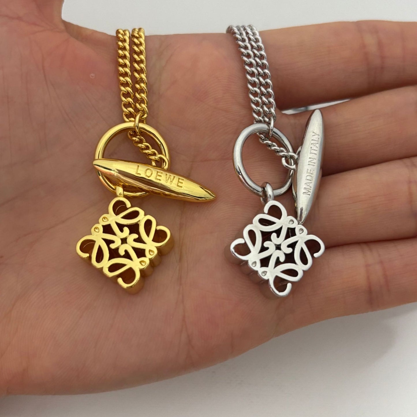  Macro shot tightly focused on the Anagram pendant, highlighting its precise form and polished finish.