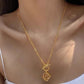  A model with a minimalist aesthetic wearing the necklace over a simple crewneck or blouse, showcasing its understated elegance.