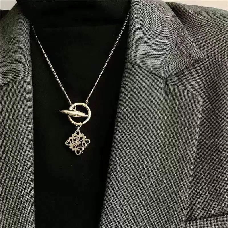  A model with a minimalist aesthetic wearing the necklace over a simple crewneck or blouse, showcasing its understated elegance.
