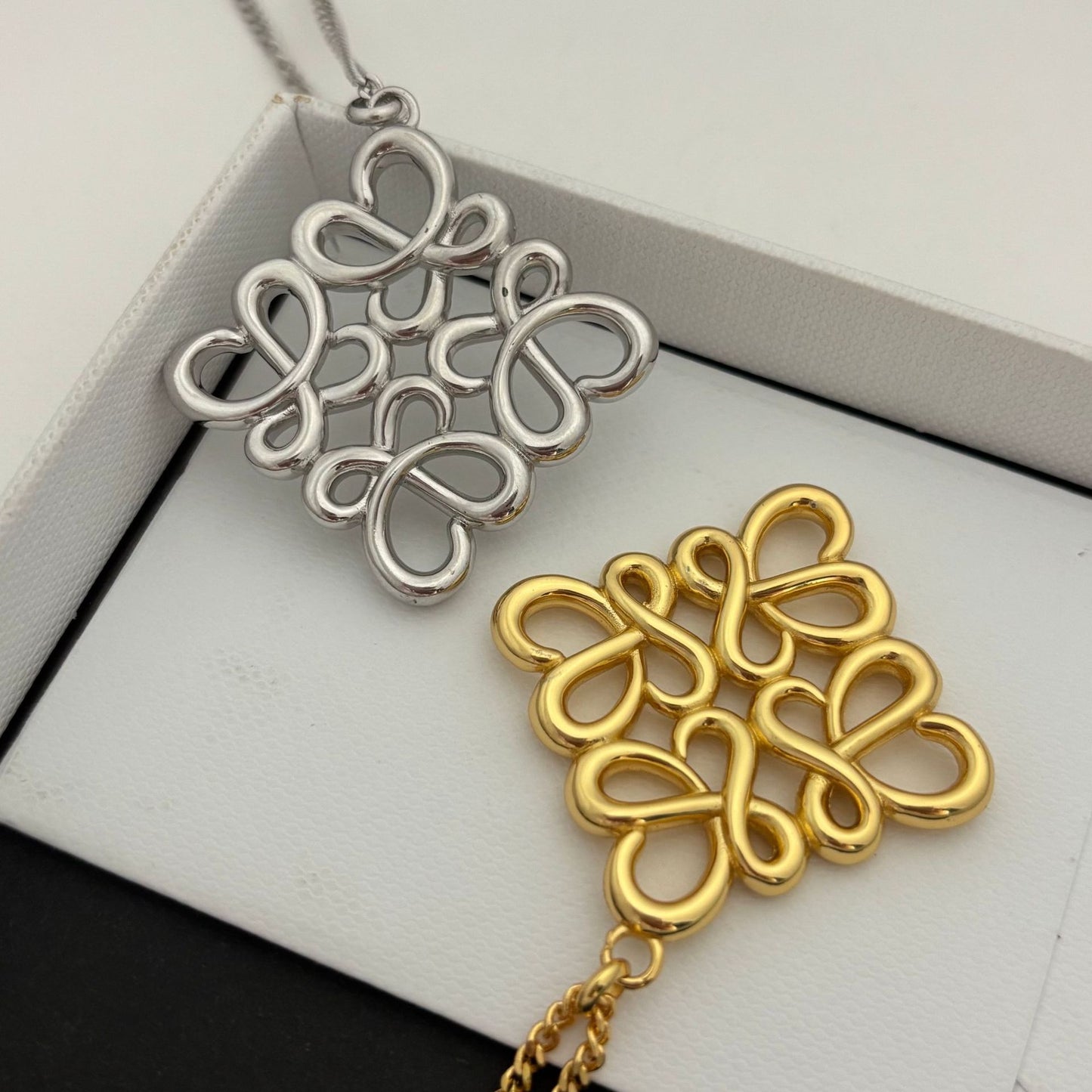  Lifestyle image of the necklace being worn over a plain cashmere sweater or turtleneck, demonstrating its intended style.