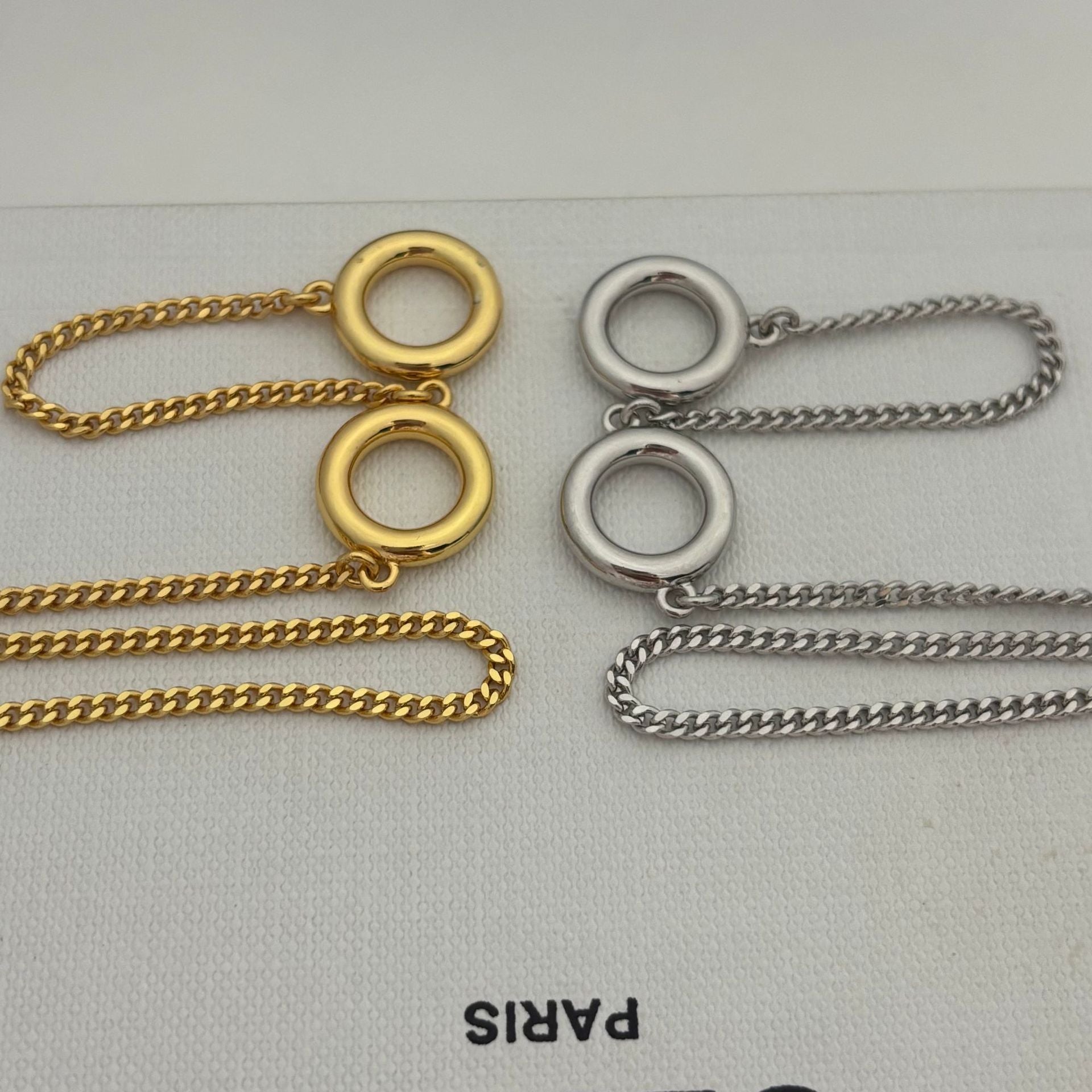  Lifestyle image of the necklace being worn over a plain cashmere sweater or turtleneck, demonstrating its intended style.