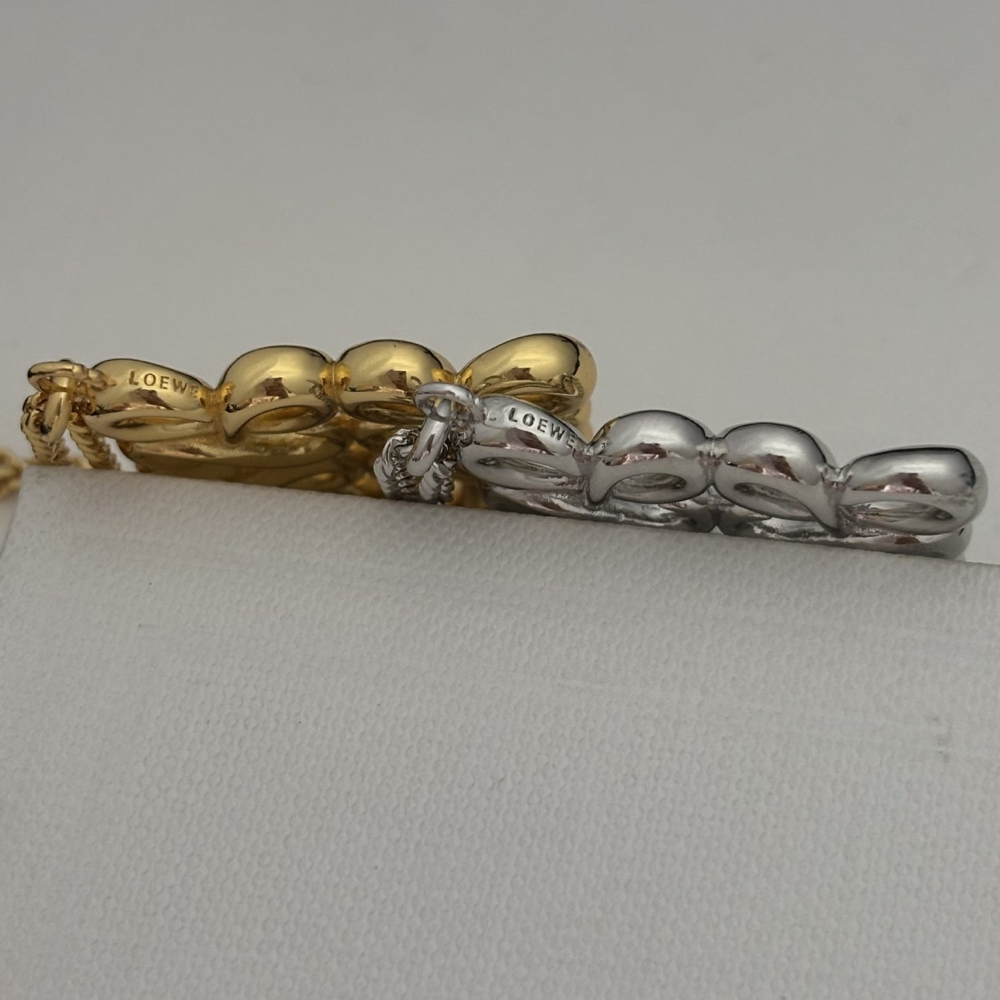  Lifestyle image of the necklace being worn over a plain cashmere sweater or turtleneck, demonstrating its intended style.