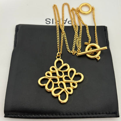 Clean shot of the necklace laid flat or styled in a loose loop, showcasing the pendant and the substantial chain.