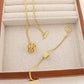 Clean, crisp shot of the necklace laid flat or worn, against a solid neutral background, focusing on the iconic pendant.