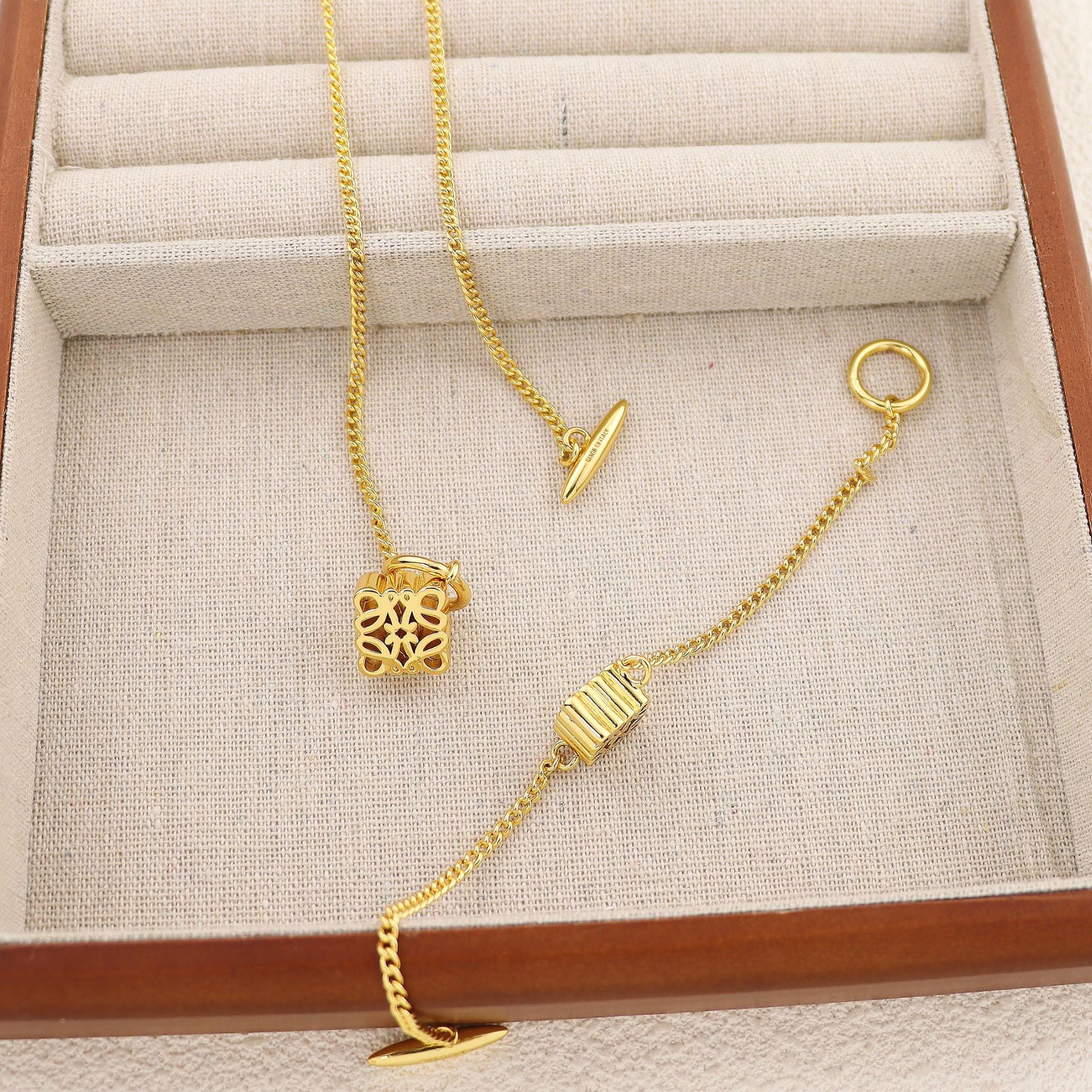 Clean, crisp shot of the necklace laid flat or worn, against a solid neutral background, focusing on the iconic pendant.