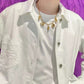  An editorial-style image of a model in minimalist clothing, using the necklace as the powerful, singular focal point.