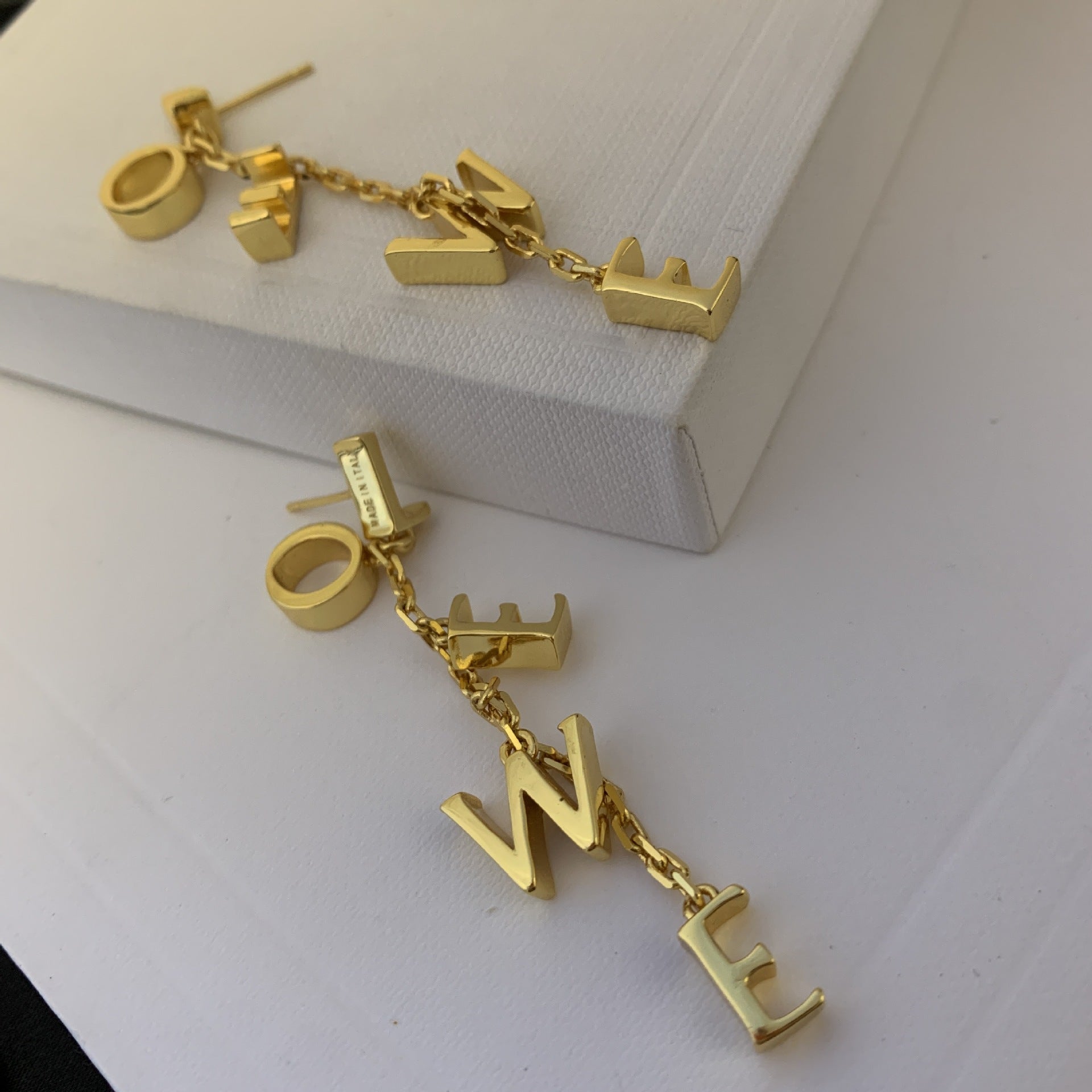 Macro shot focused on the unique link design, showcasing the sculptural details and polished finish.