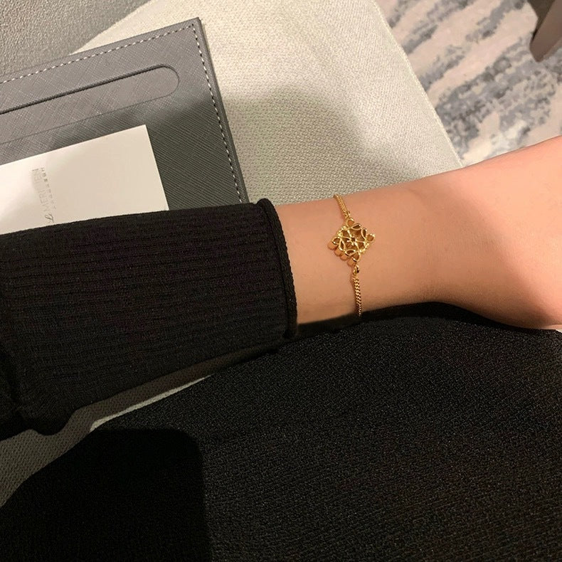 The bracelet displayed next to a modern ceramic piece or on a page of an architectural digest, reinforcing its artistic and design-forward essence