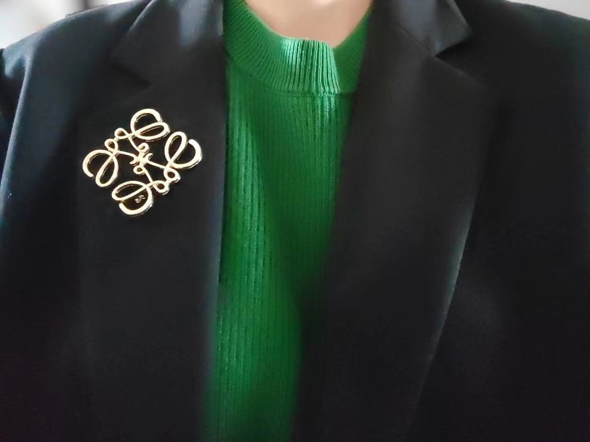  Image showing the brooch creatively styled on a handbag strap, a beret, or a plain scarf.