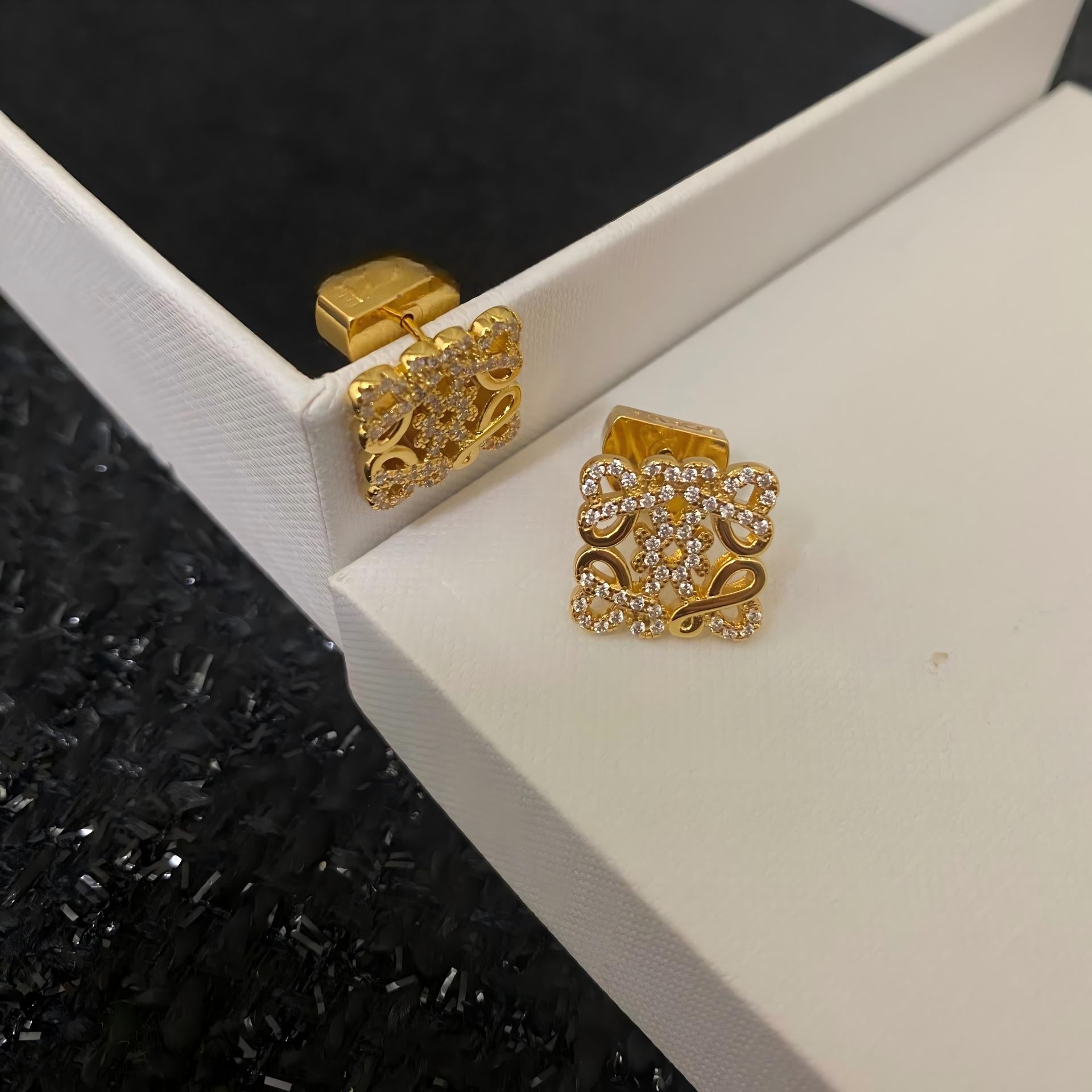 A clean, high-resolution shot of the Loewe Gold Geometric Earrings on a neutral background, showcasing their geometric shape and gold finish. Alt text: "Loewe Gold Geometric Earrings - Luxury Geometric Earrings for Women."