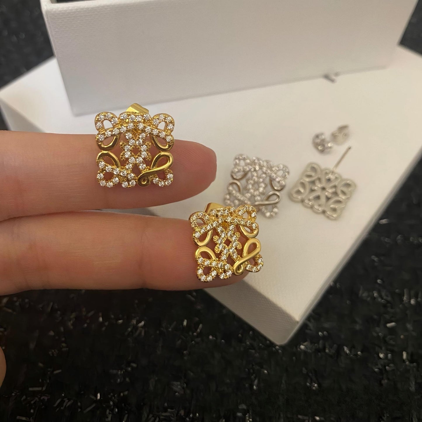 Close-up view highlighting the intricate geometric design and smooth gold plating. Alt text: "Detailed View of Loewe Geometric Earrings in Gold - High-Quality Craftsmanship."