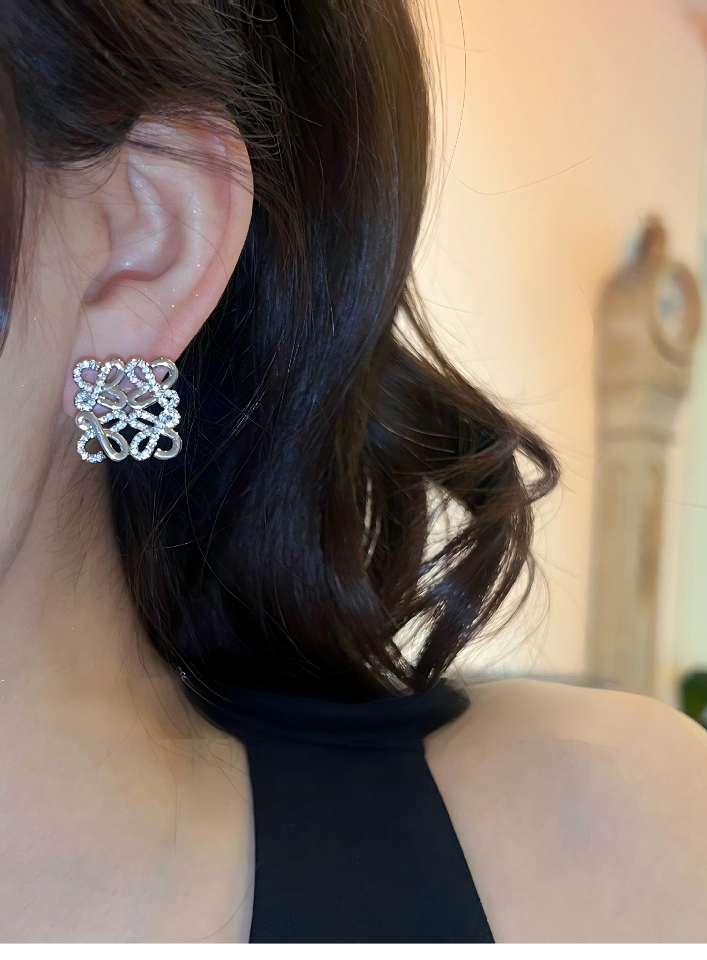 A professional photo of a model wearing the earrings, styled with casual and formal attire to demonstrate versatility. Alt text: "Model Wearing Loewe Gold Geometric Earrings - Elegant Accessory for North American Women."