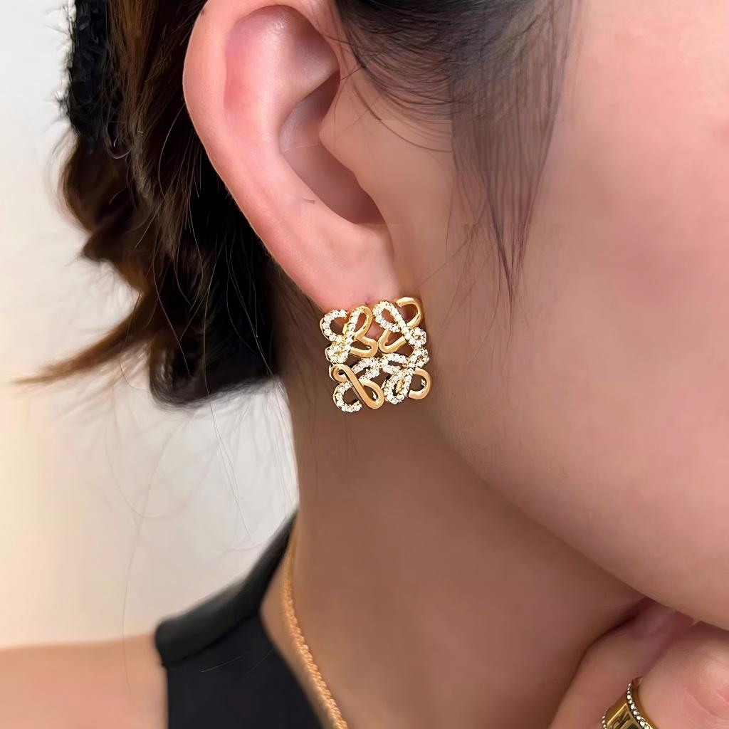 A professional photo of a model wearing the earrings, styled with casual and formal attire to demonstrate versatility. Alt text: "Model Wearing Loewe Gold Geometric Earrings - Elegant Accessory for North American Women."
