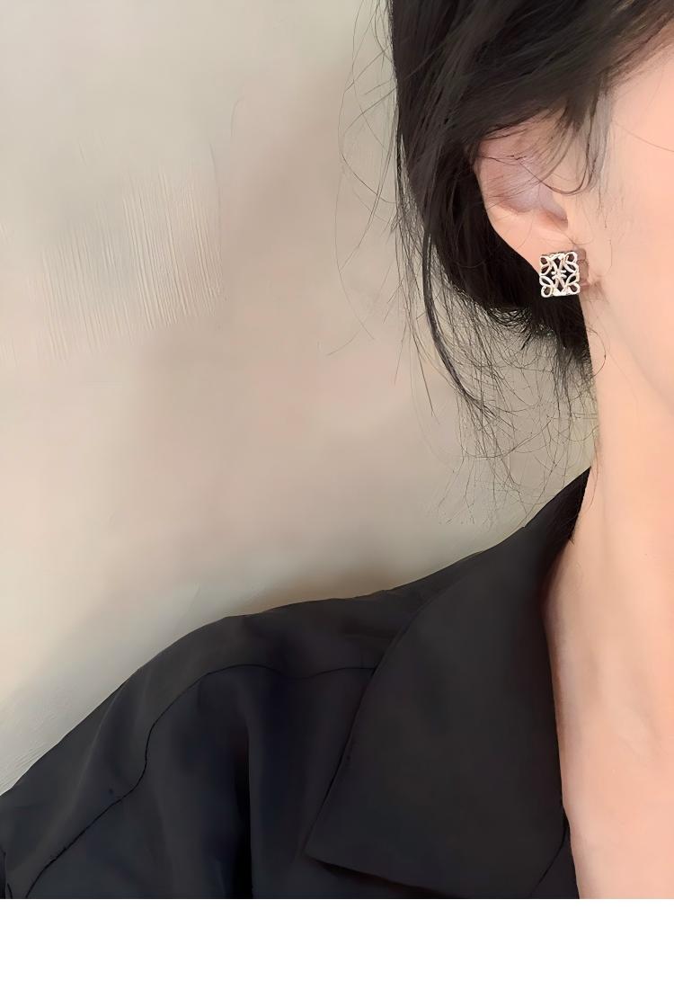 A fashion-forward North American woman wearing the earrings with a minimalist outfit (e.g., crisp white shirt or solid-color top). Focus on how the earrings add interest without overpowering.