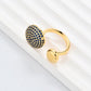 Clean, angled shot of the ring on a finger or stand, showcasing the square silhouette and intricate hollow pattern against a solid background.