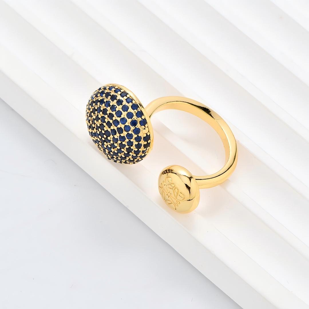 Clean, angled shot of the ring on a finger or stand, showcasing the square silhouette and intricate hollow pattern against a solid background.