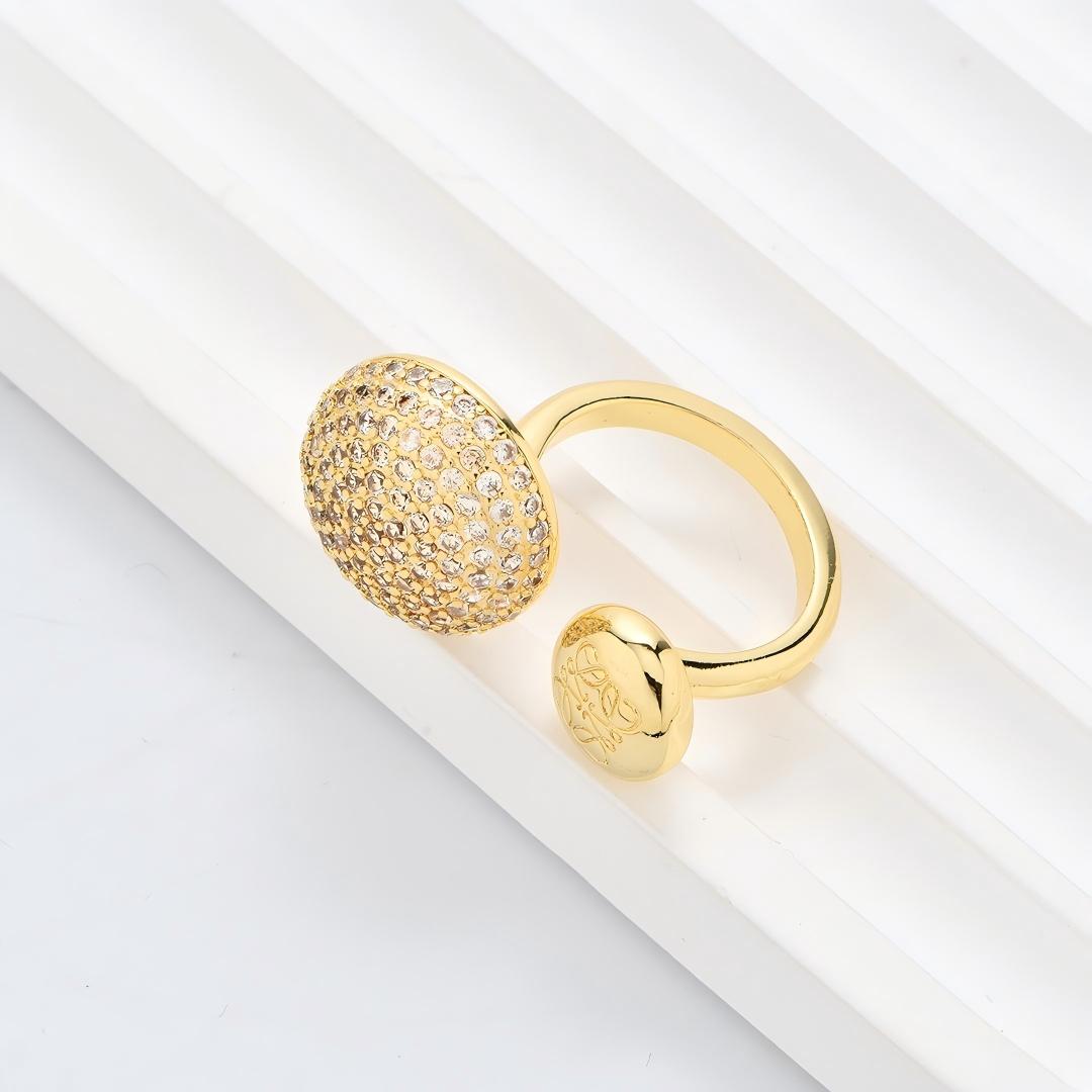 Clean, angled shot of the ring on a finger or stand, showcasing the square silhouette and intricate hollow pattern against a solid background.