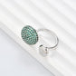 Clean, angled shot of the ring on a finger or stand, showcasing the square silhouette and intricate hollow pattern against a solid background.