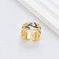 Clean, angled shot of the ring on a finger or stand, showcasing the square silhouette and intricate hollow pattern against a solid background.