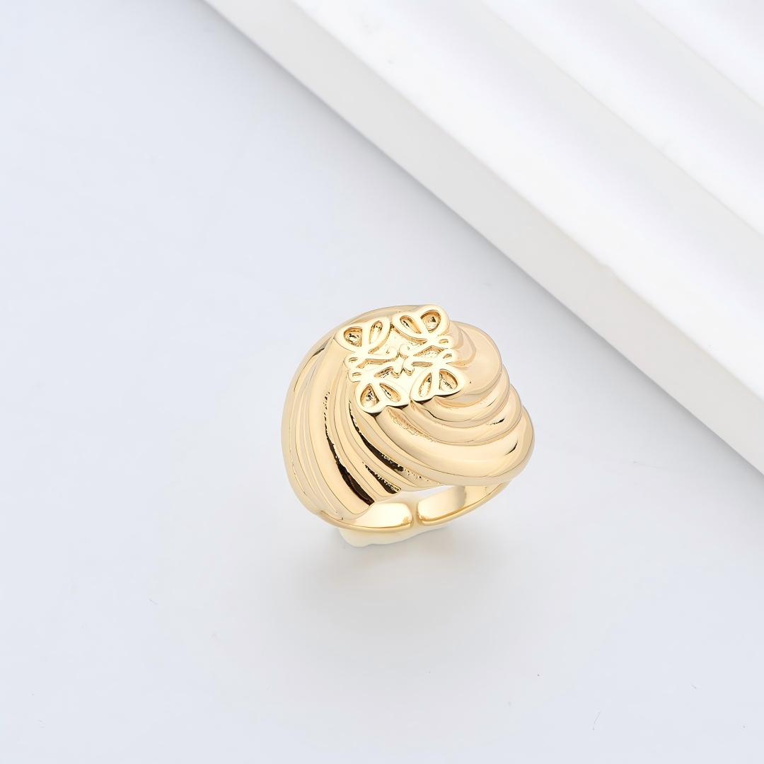 Clean, angled shot of the ring on a finger or stand, showcasing the square silhouette and intricate hollow pattern against a solid background.