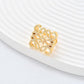Clean, angled shot of the ring on a finger or stand, showcasing the square silhouette and intricate hollow pattern against a solid background.