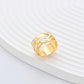 Clean, angled shot of the ring on a finger or stand, showcasing the square silhouette and intricate hollow pattern against a solid background.