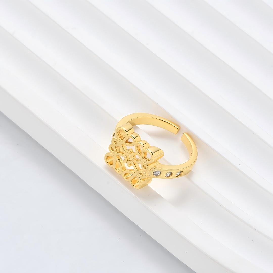 Clean, angled shot of the ring on a finger or stand, showcasing the square silhouette and intricate hollow pattern against a solid background.
