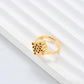 Clean, angled shot of the ring on a finger or stand, showcasing the square silhouette and intricate hollow pattern against a solid background.