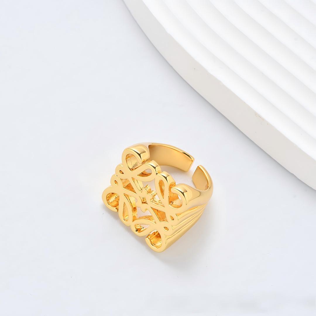 Clean, angled shot of the ring on a finger or stand, showcasing the square silhouette and intricate hollow pattern against a solid background.