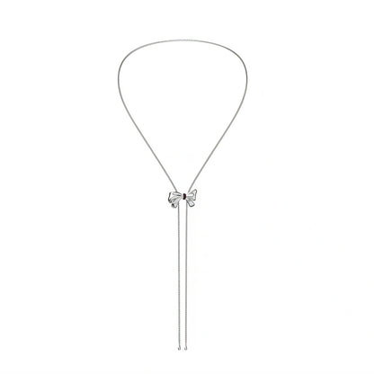 Silver necklace with a bow-shaped pendant on a white background