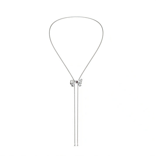 Silver necklace with a bow-shaped pendant on a white background