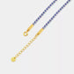 Gold chain necklace with purple beads on a light gray background