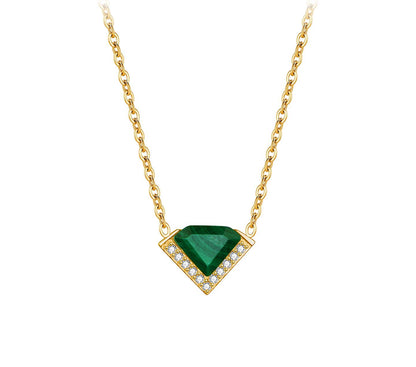 Gold necklace with a green gemstone pendant on a white background