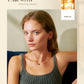 Woman wearing a gray tank top with a neutral background