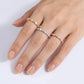 Hand wearing two diamond rings on a white background