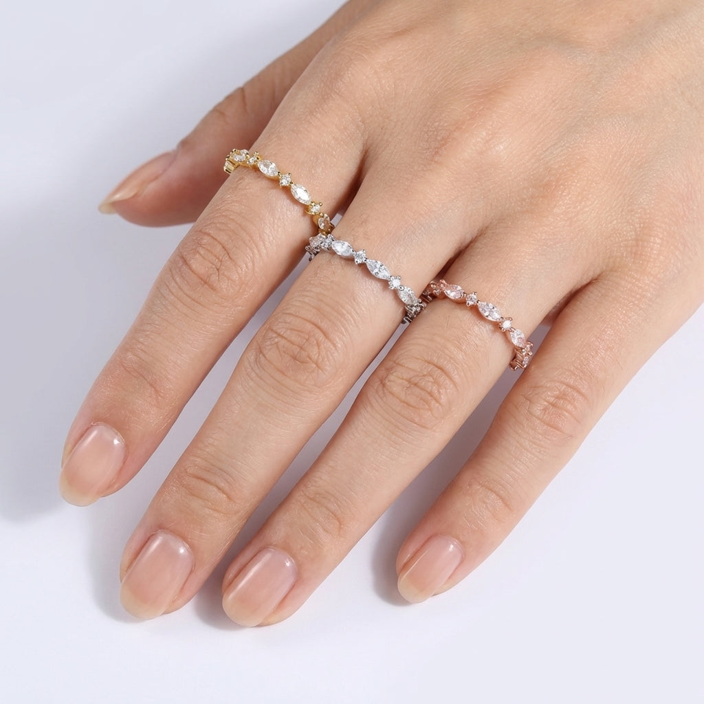 Hand wearing two diamond rings on a white background