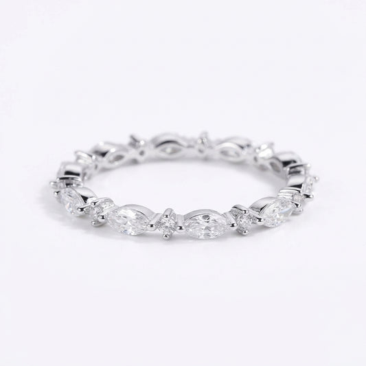 Silver ring with marquise-shaped gemstones on a white background