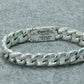 Silver bracelet with a visible brand label on a gray background