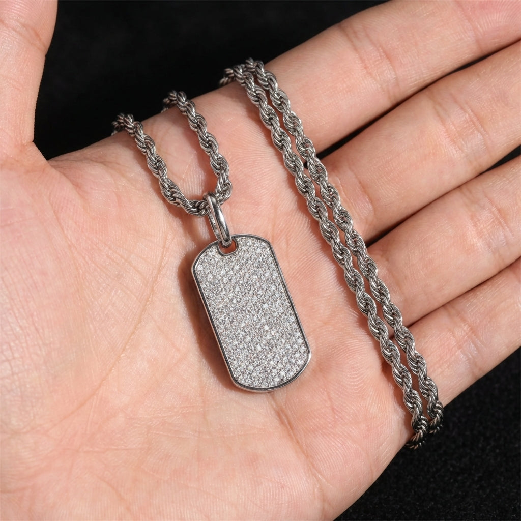 Image showing tag on a model for scale (1.0" – 1.5" width on chest).