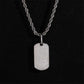 Clean white or light gray background — the chevron tag displayed on a bust form or flat surface. The geometric chevron shape catches soft light, showing high polish or brushed finish, with diamond accents sparkling subtly along the design lines.