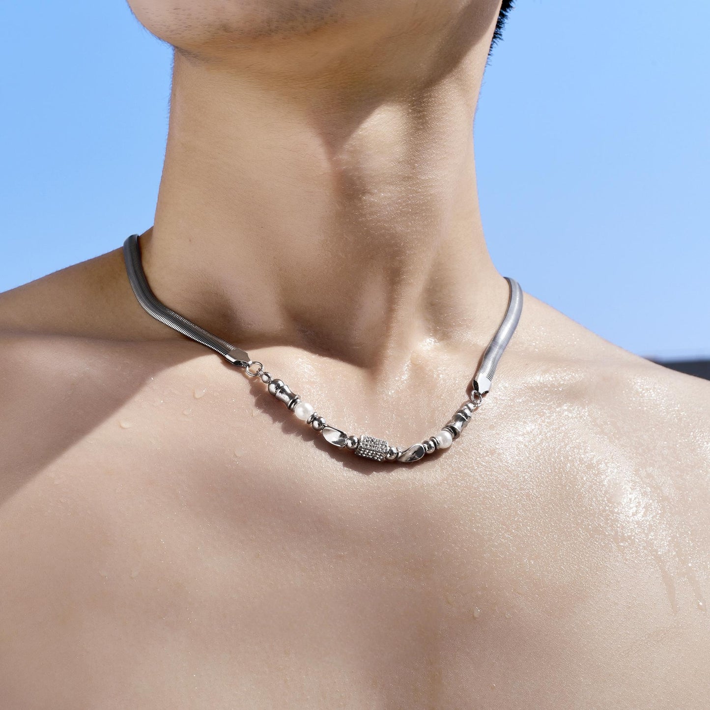 “Male model wearing sterling silver beaded snake chain minimalist streetwear”