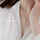 Necklace with a heart-shaped pendant worn by a person in a white outfit, with 'SHANJIN LIGHT LUXURY' branding.