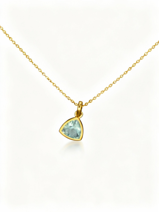 Gold necklace with a green gemstone pendant on a white background